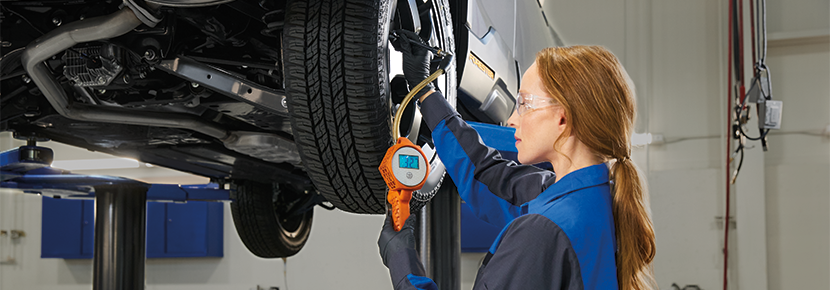 A Subaru technician checking tire pressure. | Fitzgerald Subaru Rockville in Rockville MD