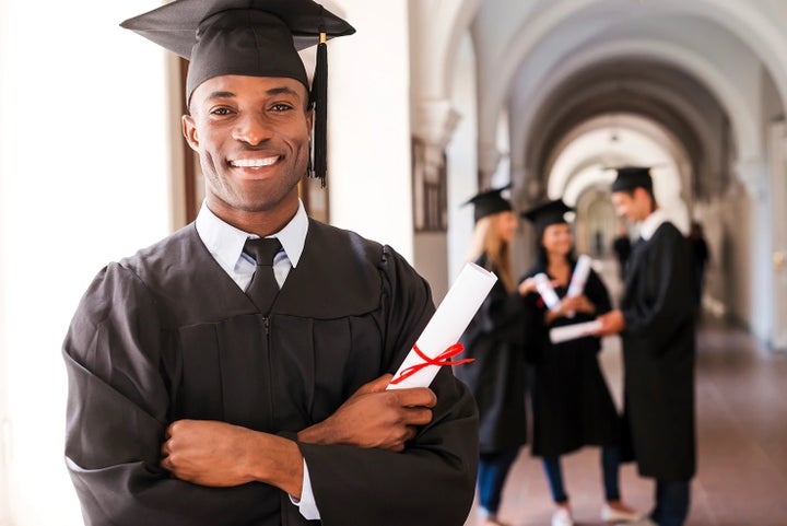 college graduate holding his diploma | Fitzgerald Subaru Rockville in Rockville MD