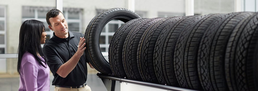 Subaru service representative showing customer a tire. | Fitzgerald Subaru Rockville in Rockville MD